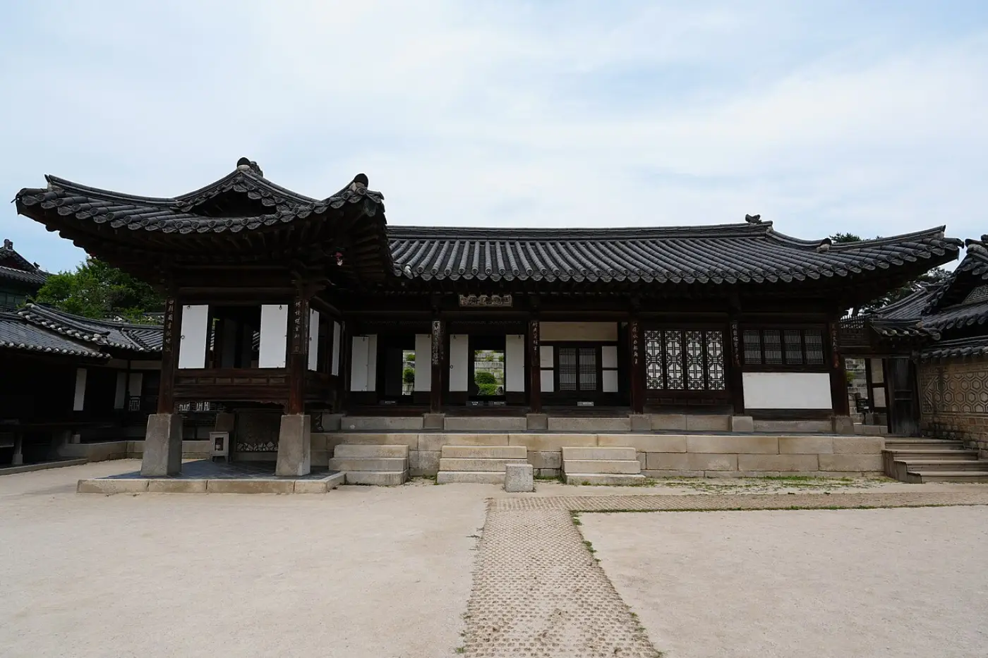 Nakseonjae at Changdeokgung, a plain unpainted wooden building facing a courtyard
